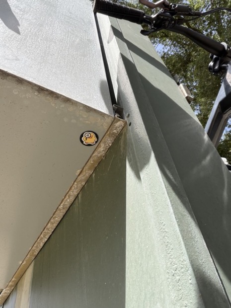 A duck tag stuck to the edge of a metal bike rack